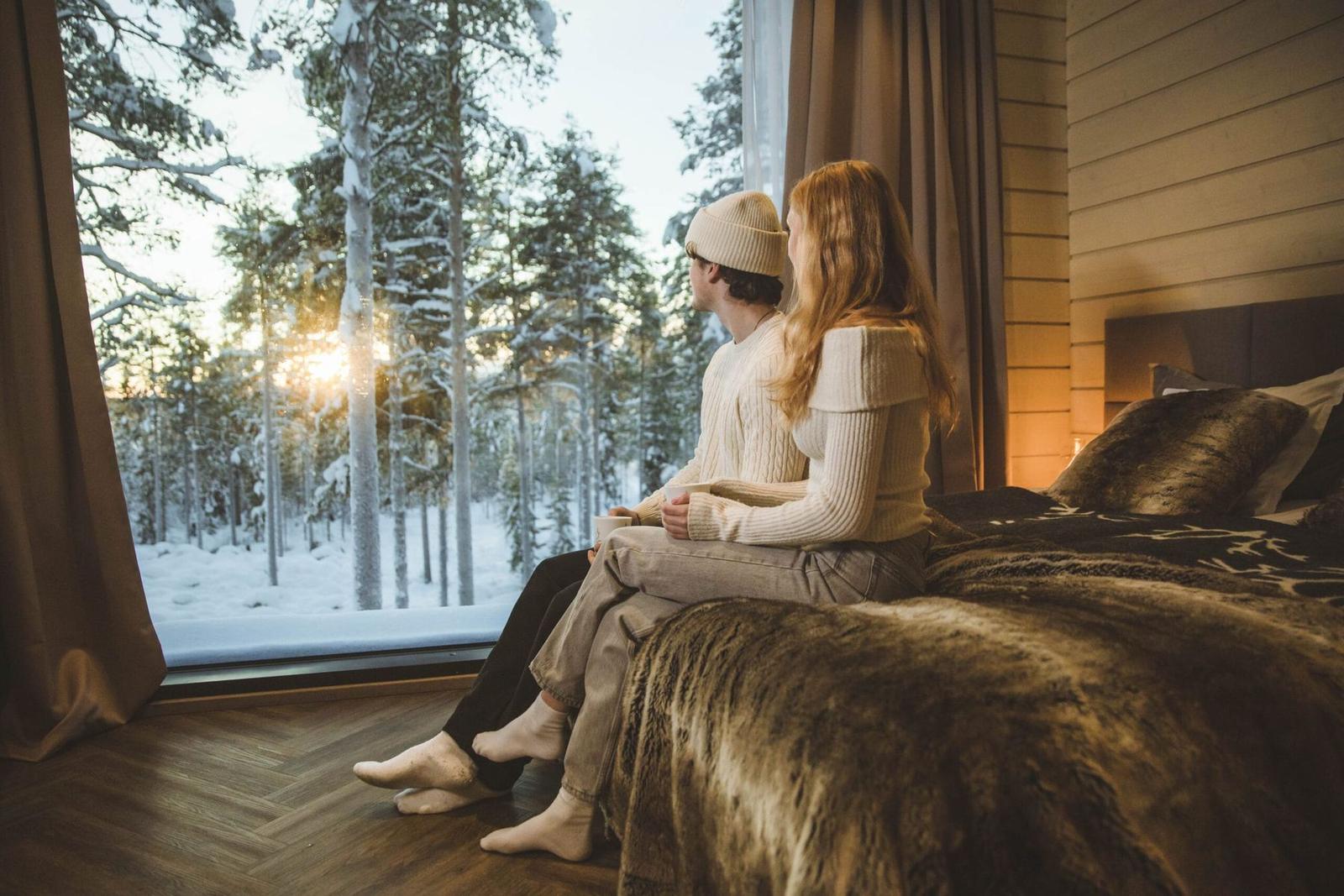 Couple on the bed with a winter view