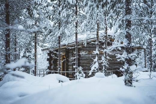 Log Cabin in deep snow with lit windows