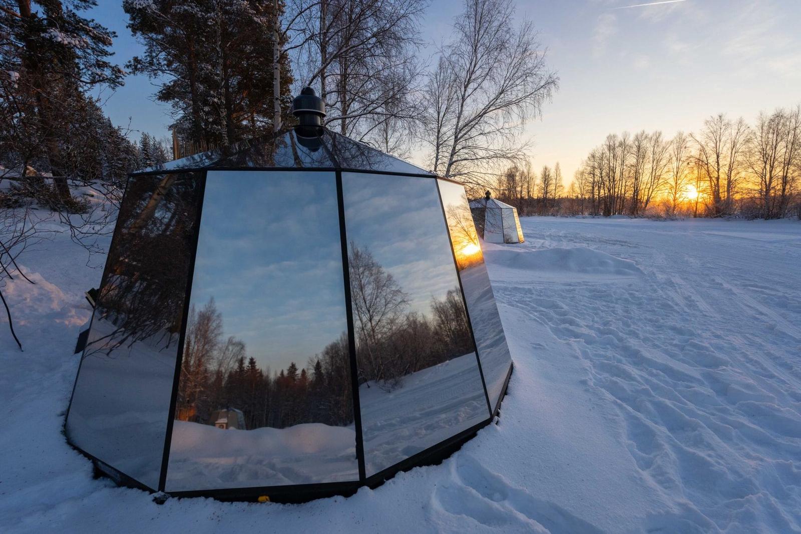 Mirrored igloo at a snowy sunset