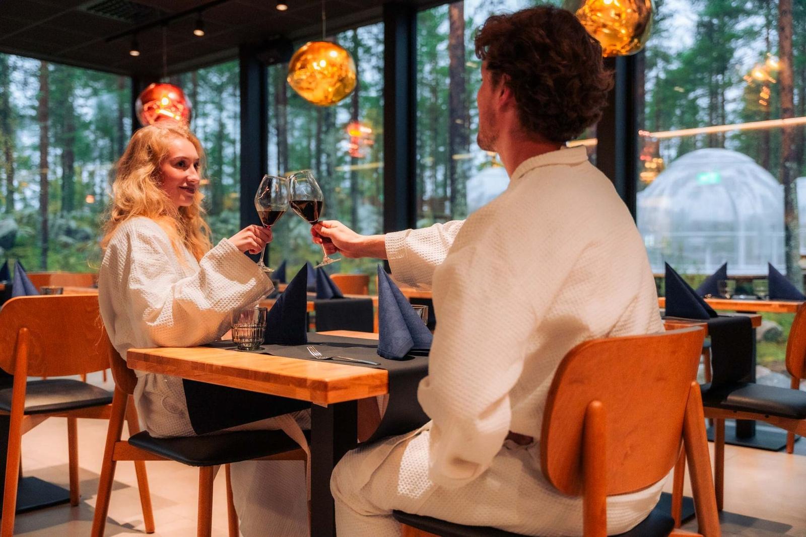 Two guests toasting by the window
