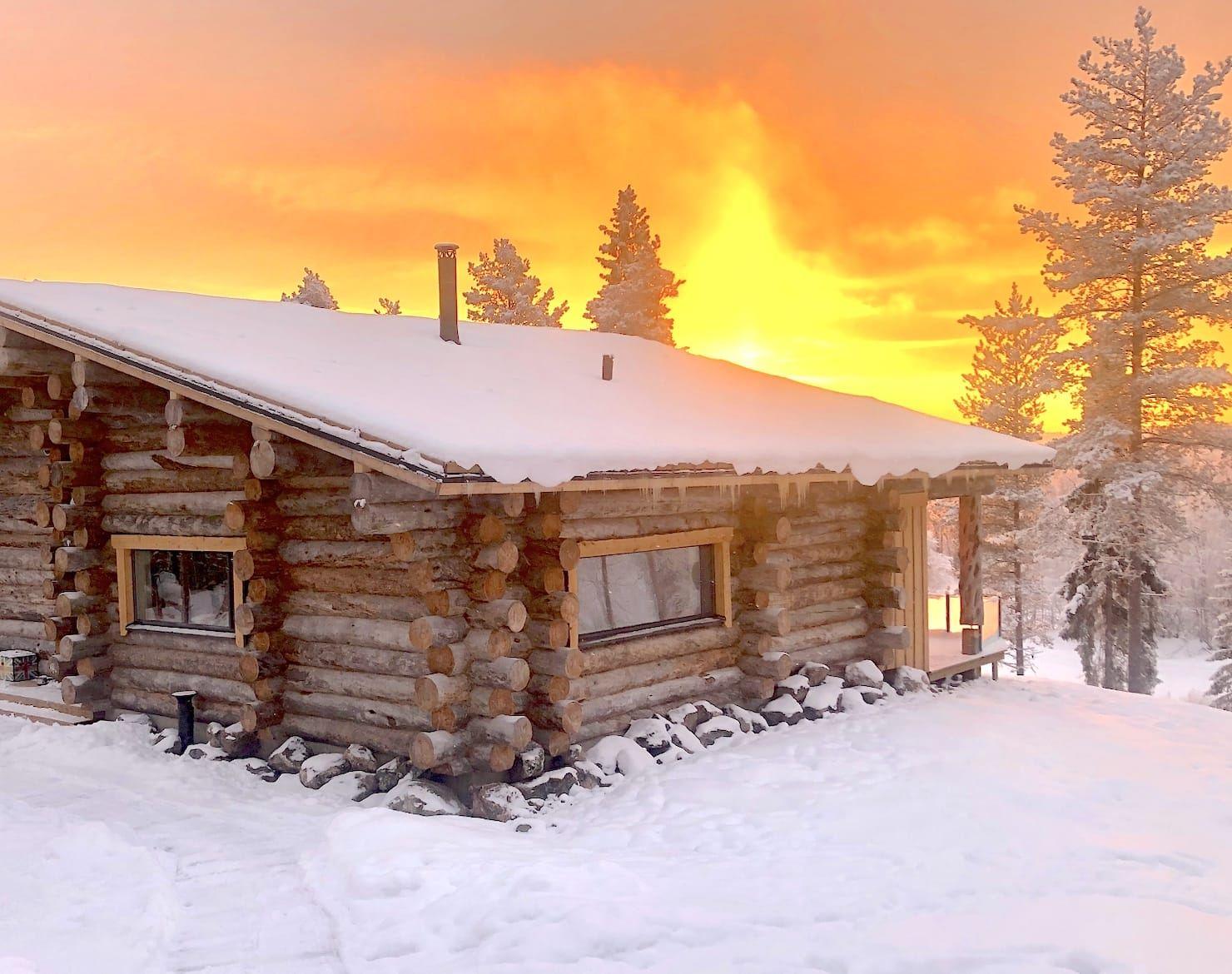 Log villa at a fiery sunset